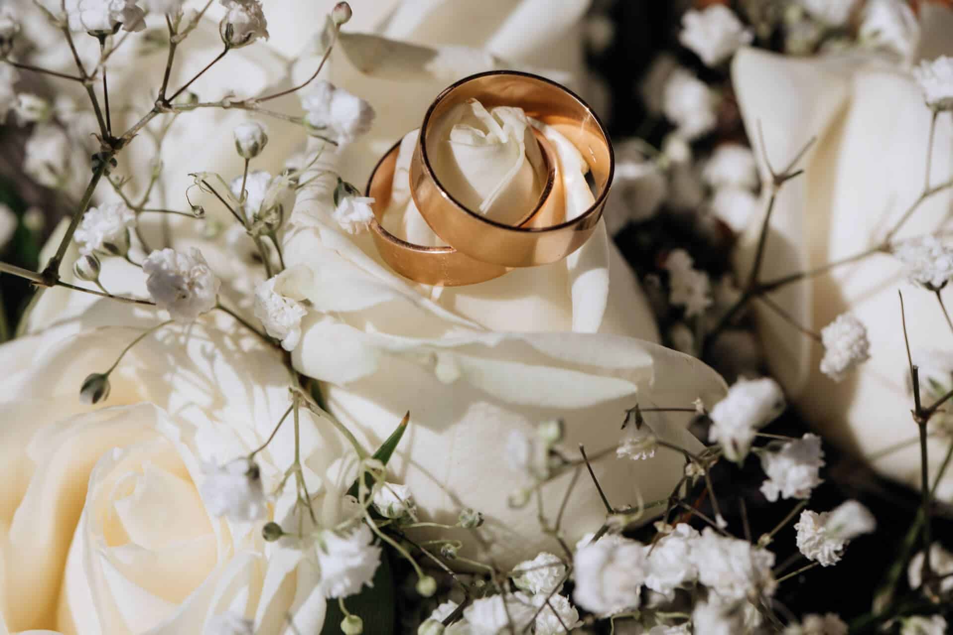 golden-wedding-rings-white-rose-from-wedding-bouquet SMALL.jpg